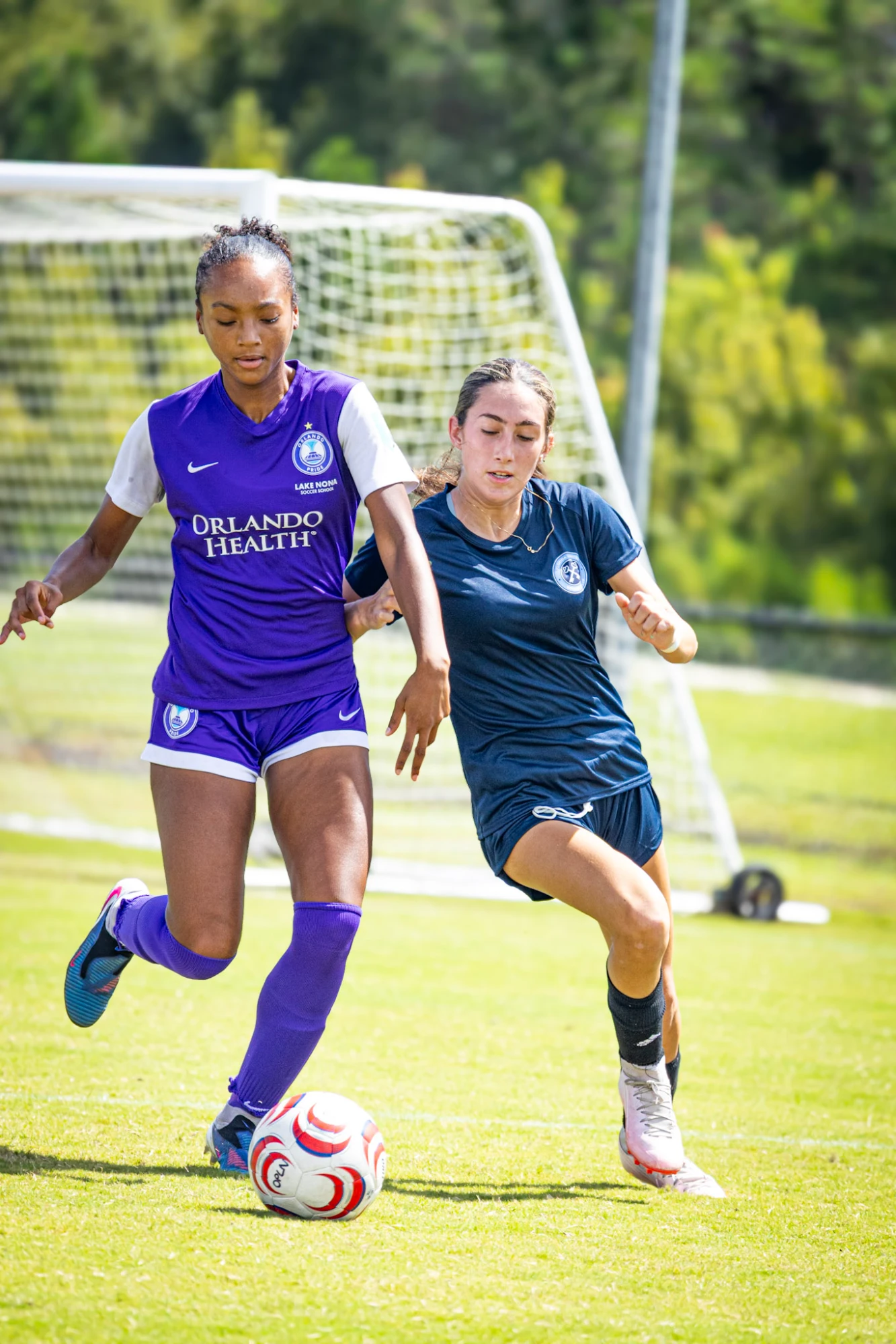 Two players battling for the ball in front of goal